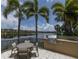 Community grilling area and table overlooking a peaceful lake and upscale condo buildings at 10520 Boardwalk Loop # 202, Bradenton, FL 34202