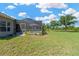 Lush backyard with a screened pool, offering privacy and a tranquil outdoor retreat by the pond at 11153 Biddeford Pl, New Port Richey, FL 34654