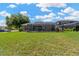 Large, well-maintained backyard featuring a screened pool enclosure for year-round enjoyment at 11153 Biddeford Pl, New Port Richey, FL 34654