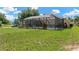 Expansive backyard with lush lawn and screened pool, perfect for outdoor relaxation and entertainment at 11153 Biddeford Pl, New Port Richey, FL 34654