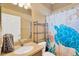 Bathroom featuring a printed shower curtain, shelving, vanity, and nautical themed decor at 11153 Biddeford Pl, New Port Richey, FL 34654