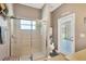 Bathroom with a glass shower door, exterior door and neutral wall color at 11153 Biddeford Pl, New Port Richey, FL 34654