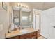 Bathroom vanity with brown cabinets, cream countertop, decor, and door to second room at 11153 Biddeford Pl, New Port Richey, FL 34654
