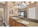 Bathroom with double sink vanity, tile floors, and a large mirror with modern lighting at 11153 Biddeford Pl, New Port Richey, FL 34654