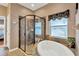 Bathroom featuring a soaking tub, frameless shower and decorative tile at 11153 Biddeford Pl, New Port Richey, FL 34654