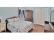 Cozy bedroom with wood floors featuring a closet, and a bed with blue bedding at 11153 Biddeford Pl, New Port Richey, FL 34654