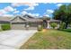 Charming single-Gathering home featuring a three-car garage and a well-manicured lawn, perfect for suburban living at 11153 Biddeford Pl, New Port Richey, FL 34654