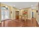 Inviting foyer featuring hardwood floors, natural light, and an elegant dining area, perfect for welcoming guests at 11153 Biddeford Pl, New Port Richey, FL 34654