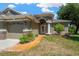 Elegant front entrance with a decorative walkway, stone accents, and a welcoming glass door with sidelights at 11153 Biddeford Pl, New Port Richey, FL 34654