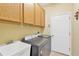 Functional laundry room featuring ample cabinet storage and modern washer and dryer at 11153 Biddeford Pl, New Port Richey, FL 34654