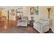 Open-concept living area with hardwood floors and comfortable seating, flowing seamlessly into the adjacent rooms at 11153 Biddeford Pl, New Port Richey, FL 34654