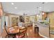 Open-concept living space featuring hardwood floors and seamless flow between the dining area, living room, and kitchen at 11153 Biddeford Pl, New Port Richey, FL 34654