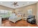 Bright main bedroom featuring a ceiling fan, hardwood floors, and two windows at 11153 Biddeford Pl, New Port Richey, FL 34654