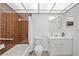 Well-maintained bathroom with tub, toilet, vanity, and neutral-toned tiles at 11799 Raintree Dr, Temple Terrace, FL 33617