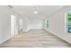 Bright, spacious bedroom with light gray floors, a ceiling fan, and lots of natural light from the windows at 11799 Raintree Dr, Temple Terrace, FL 33617
