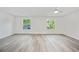 Spacious bedroom with two windows and bright laminate flooring at 11799 Raintree Dr, Temple Terrace, FL 33617