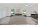 Bright bedroom with two windows, ceiling fan, and contemporary furnishings at 11799 Raintree Dr, Temple Terrace, FL 33617