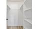 Walk-in closet with built-in shelving and rod for organized storage solutions at 11799 Raintree Dr, Temple Terrace, FL 33617