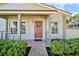 Inviting front entryway with a decorated door, lush landscaping, and charming details at 11799 Raintree Dr, Temple Terrace, FL 33617
