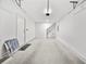 Clean, spacious garage featuring a finished concrete floor and white painted walls at 11799 Raintree Dr, Temple Terrace, FL 33617