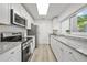 Updated kitchen with stainless steel appliances, granite countertops, and ample cabinet space at 11799 Raintree Dr, Temple Terrace, FL 33617