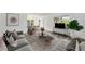 Cozy living room with stylish furnishings, a modern entertainment center, and ample seating at 11799 Raintree Dr, Temple Terrace, FL 33617