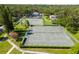 Overhead view of the community's well-maintained tennis courts with manicured lawns and established landscaping at 11799 Raintree Dr, Temple Terrace, FL 33617