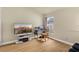 Versatile bedroom with wood-look floors and a window, ideal for a home office or guest room at 12031 Mountbatten Dr, Tampa, FL 33626