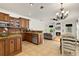 Open kitchen features wood cabinets, granite countertops, and stainless steel appliances at 12031 Mountbatten Dr, Tampa, FL 33626