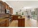 Modern kitchen with stainless steel appliances, granite countertops and an island; view to dining and pool at 12031 Mountbatten Dr, Tampa, FL 33626
