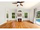 Bright living room featuring wood floors, fireplace and a view of the pool through sliding glass doors at 12031 Mountbatten Dr, Tampa, FL 33626