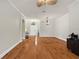 Open-concept living room with hardwood floors, crown molding, and decorative light fixtures at 12031 Mountbatten Dr, Tampa, FL 33626