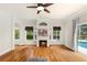 Bright living room with hardwood floors, a fireplace, and sliding doors to the pool at 12031 Mountbatten Dr, Tampa, FL 33626