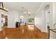 Open-concept living area with hardwood floors, neutral walls, and views of the kitchen and pool area at 12031 Mountbatten Dr, Tampa, FL 33626