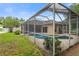Beautiful screened-in pool area surrounded by lush landscaping, offering a private outdoor oasis at 12031 Mountbatten Dr, Tampa, FL 33626