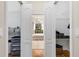 Organized walk-in closet with shelving, bi-fold doors, and bathroom views at 12031 Mountbatten Dr, Tampa, FL 33626