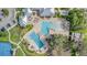Aerial view of community pools, tennis courts, parking and a clubhouse with beautiful landscaping at 13194 Royal Pines Ave, Riverview, FL 33579