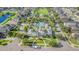 Aerial view of a community clubhouse with swimming pool, manicured lawns, and beautiful landscaping at 13194 Royal Pines Ave, Riverview, FL 33579