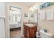 Bathroom featuring a vanity with sink, framed mirror and tiled flooring at 13194 Royal Pines Ave, Riverview, FL 33579