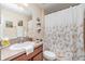 This bathroom has a decorative shower curtain, dark wood cabinets, and modern fixtures at 13194 Royal Pines Ave, Riverview, FL 33579