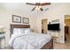 Bright bedroom equipped with ceiling fan, tv and ensuite bathroom at 13194 Royal Pines Ave, Riverview, FL 33579