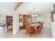 Traditional dining room with a wooden table set for six, complemented by a china cabinet and neutral decor at 13194 Royal Pines Ave, Riverview, FL 33579