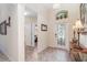 Inviting foyer with decorative tile flooring, high ceilings, and an arched window above the ornate front door at 13194 Royal Pines Ave, Riverview, FL 33579