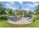 Outdoor gazebo with brick and column supports, blue benches, and a weather vane at 13194 Royal Pines Ave, Riverview, FL 33579