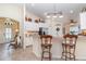 Bright kitchen featuring white cabinets, granite countertops, a breakfast bar, and stainless steel appliances at 13194 Royal Pines Ave, Riverview, FL 33579