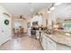 Modern kitchen with granite countertops, stainless steel appliances, a breakfast bar, and adjacent dining area at 13194 Royal Pines Ave, Riverview, FL 33579