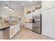 This kitchen is equipped with stainless steel refrigerator and granite countertops at 13194 Royal Pines Ave, Riverview, FL 33579