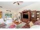 Cozy living room with a large, plush leather sectional, decorative rug, and access to the outdoor patio at 13194 Royal Pines Ave, Riverview, FL 33579