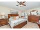 Comfortable main bedroom has ceiling fan and beautiful furnishings at 13194 Royal Pines Ave, Riverview, FL 33579