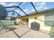 Enclosed patio features outdoor chairs, grill, and access to the lawn at 13194 Royal Pines Ave, Riverview, FL 33579